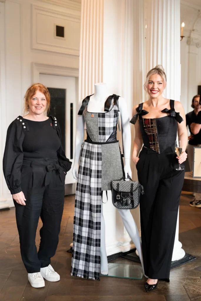 Siobhan Mackenzie posing with a guest beside a mannequin dressed in a black and white tartan outfit at Blythswood Square Hotel