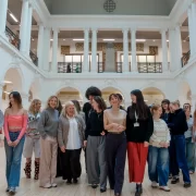 Edinburgh College of Art fashion students and Multrees Walk team standing together inside the Sculpture Court at ECA to mark the start of their new mentorship partnership.