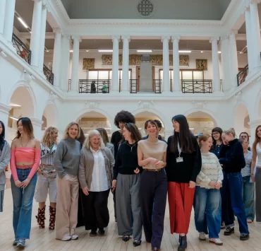 Edinburgh College of Art fashion students and Multrees Walk team standing together inside the Sculpture Court at ECA to mark the start of their new mentorship partnership.