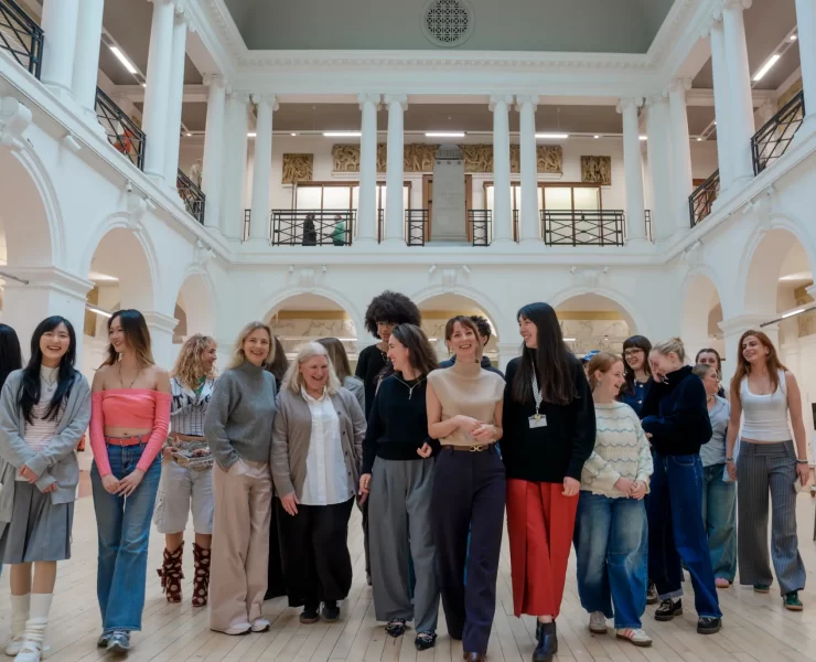 Edinburgh College of Art fashion students and Multrees Walk team standing together inside the Sculpture Court at ECA to mark the start of their new mentorship partnership.