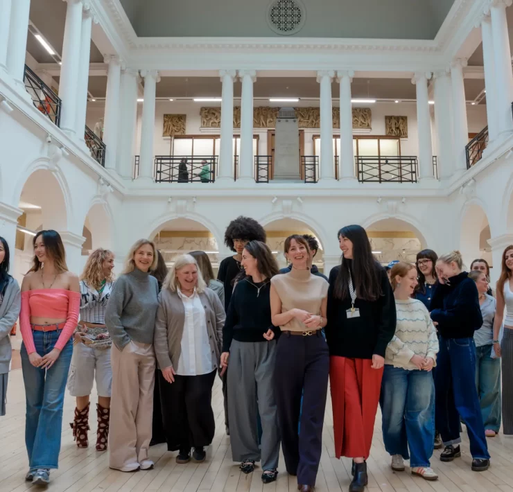 Edinburgh College of Art fashion students and Multrees Walk team standing together inside the Sculpture Court at ECA to mark the start of their new mentorship partnership.