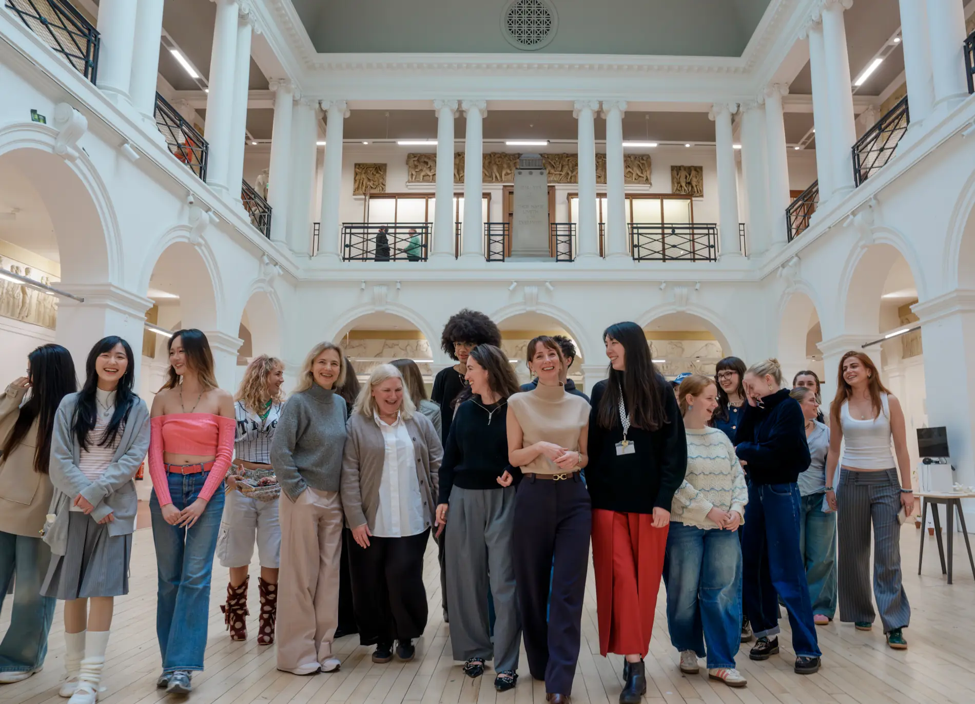 Edinburgh College of Art fashion students and Multrees Walk team standing together inside the Sculpture Court at ECA to mark the start of their new mentorship partnership.