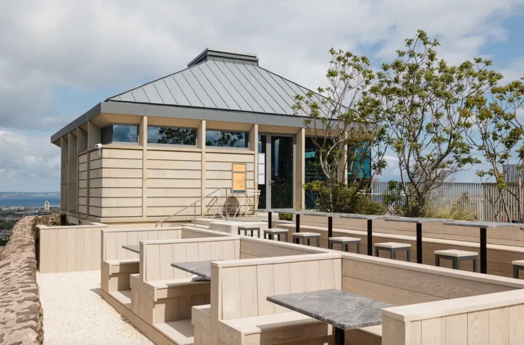 Exterior of Café Calton on Calton Hill in Edinburgh, showing outdoor seating and panoramic city views.