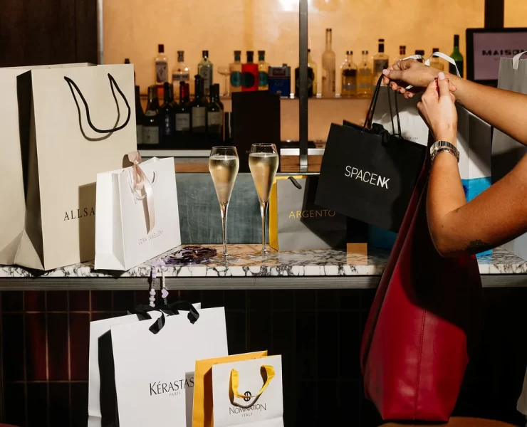 Champagne glasses and shopping bags from AllSaints, Space NK and other brands at Princes Square Glasgow.