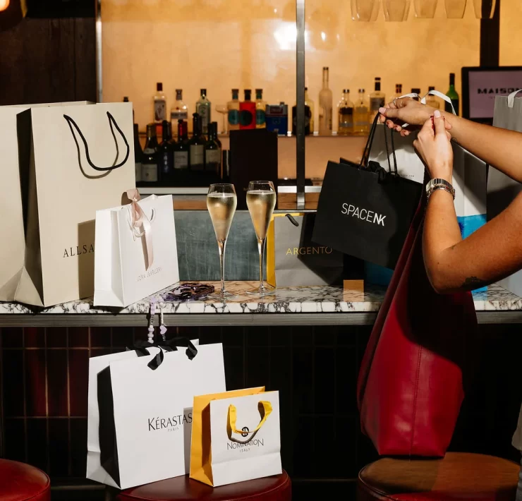 Champagne glasses and shopping bags from AllSaints, Space NK and other brands at Princes Square Glasgow.