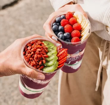 Two açaí bowls topped with fruit and granola from OAKBERRY Açaí Edinburgh.