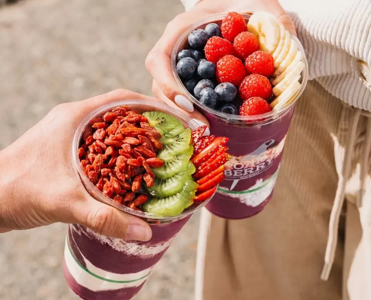 Two açaí bowls topped with fruit and granola from OAKBERRY Açaí Edinburgh.