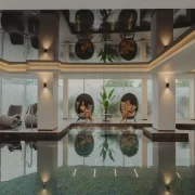 Indoor spa pool with relaxation loungers and seating at The Cairndale Hotel & Spa in Dumfries.