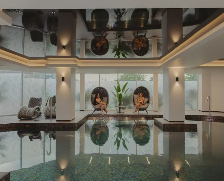 Indoor spa pool with relaxation loungers and seating at The Cairndale Hotel & Spa in Dumfries.