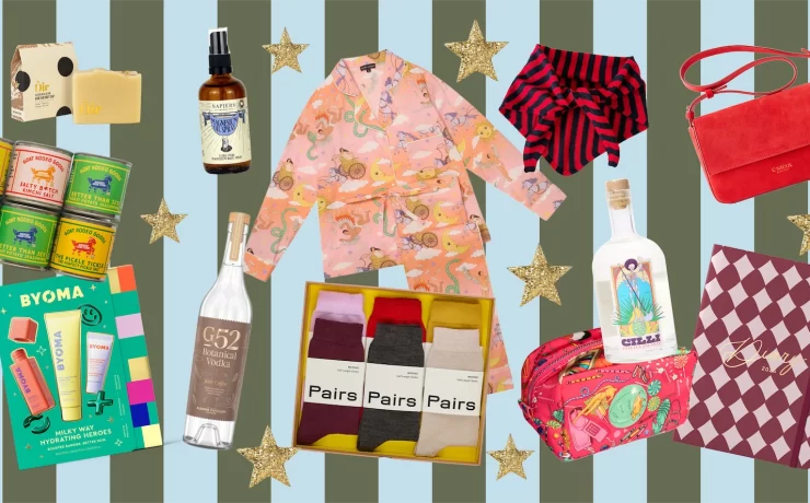 Festive collage of Christmas gift ideas including Oir festive soap, Napiers magnesium oil spray, Karen Mabon pyjamas, La Fetiche striped neck scarf, C.Nicol red suede bag, BYOMA skincare set, G52 Botanical Vodka, Pairs luxury socks, Cillí Tequila Picante, Goat Rodeo seasonings, and a patterned 2025 diary, arranged on a striped background with gold stars.