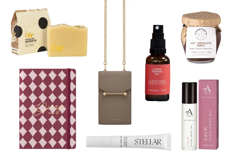 Flat lay of Quine’s Christmas stocking fillers including Oir Festive Gold soap, Strathberry mosaic phone pouch, Laura Thomas Co. Christmas Spritz Mist, Edinburgh Honey Co. Hot Chocolate Honey, Busy B 2026 diary, Dr David Jack Stellar eye cream, and Arran Naturals Calm Pulse Point Oil.
